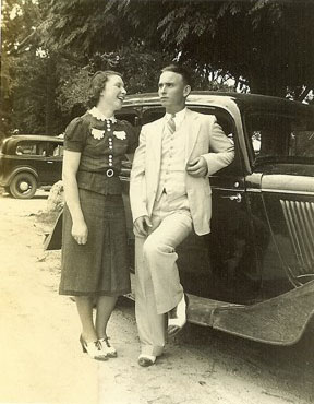 Hilda and Cedric Hales stand together by a car in 1938.
